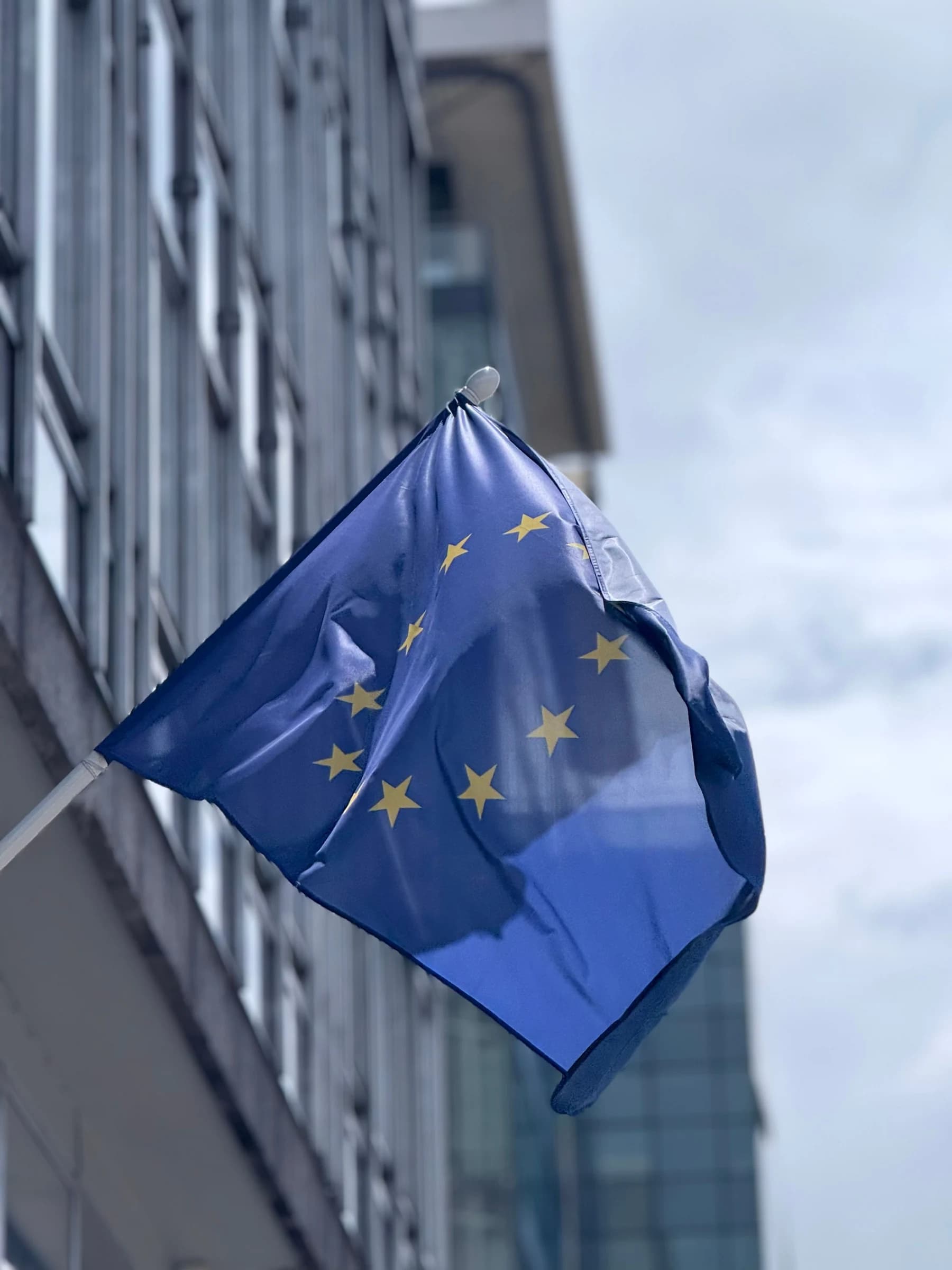 European flag in Hemptex® hemp fabric flying from a pole on the facade of an office building