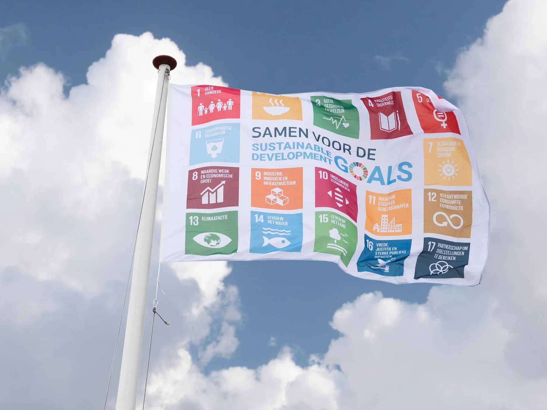 SDG flag with the 17 Sustainable Development Goals on a white flagpole, available in Hemptex® hemp or CiCLO® polyester